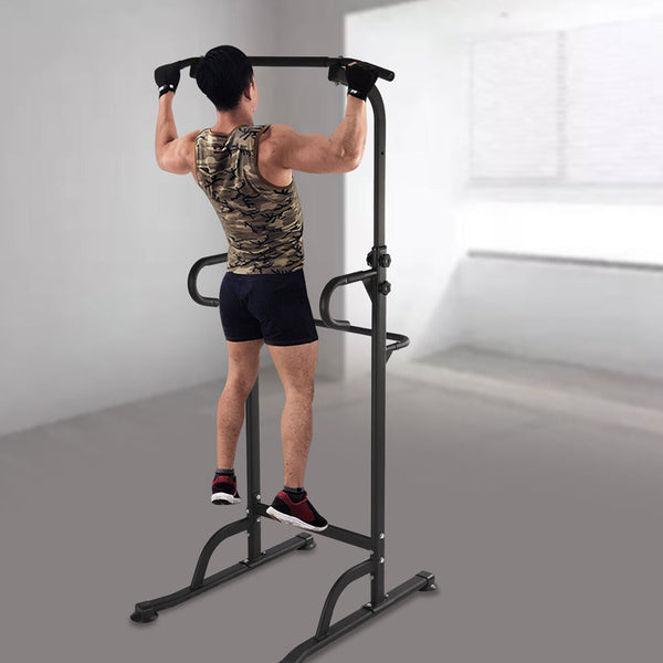 Person exercising on a pull-up and dip station
