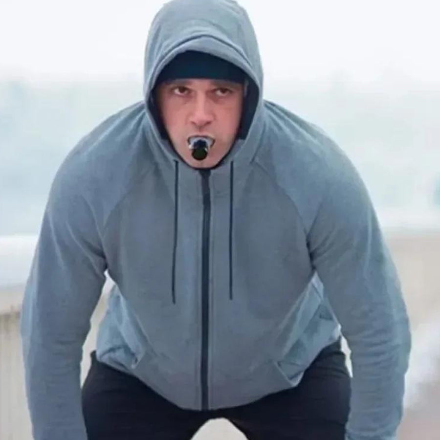 Person using a handheld breathing trainer