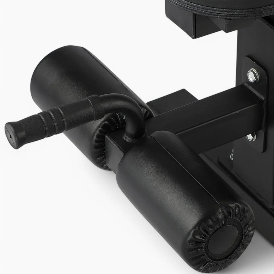 Close-up of leg rollers on a weight bench