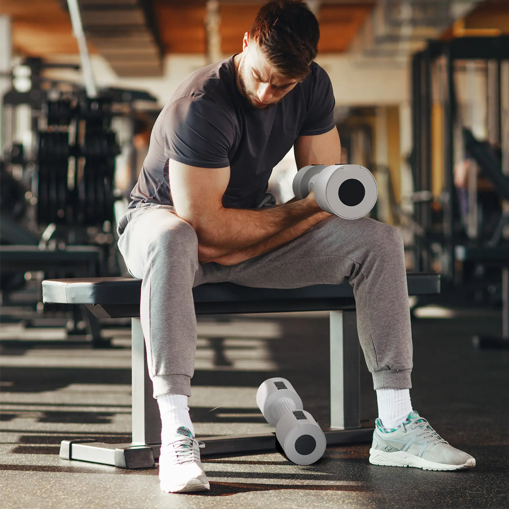 Person exercising with light-coloured dumbbells