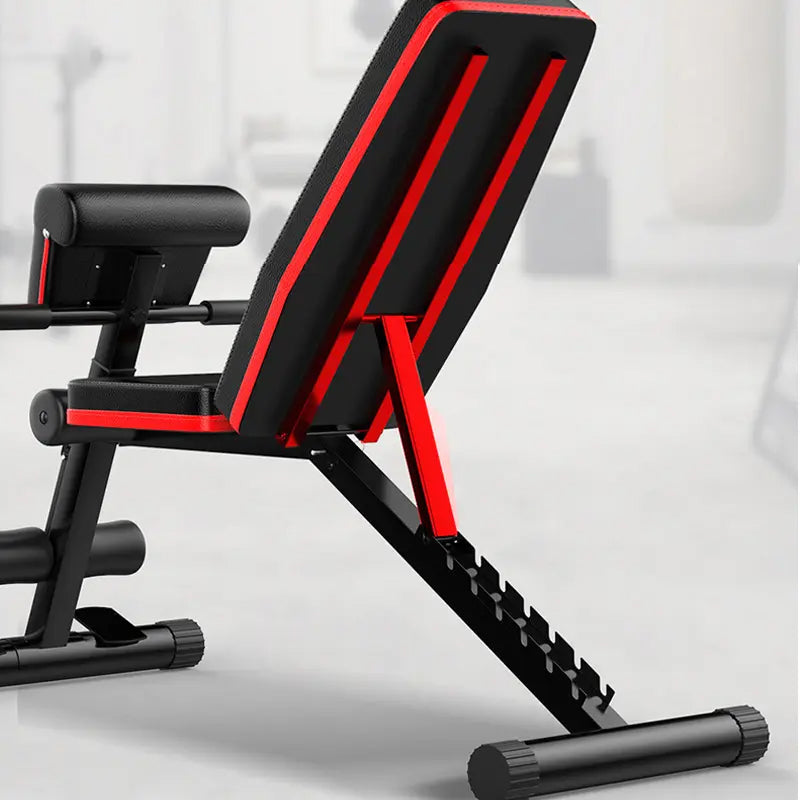 Close-up of a weight bench backrest and leg rollers