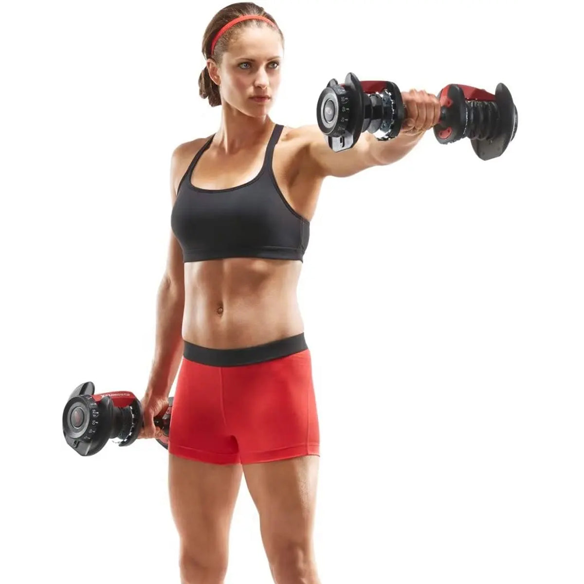 Person exercising with adjustable dumbbells