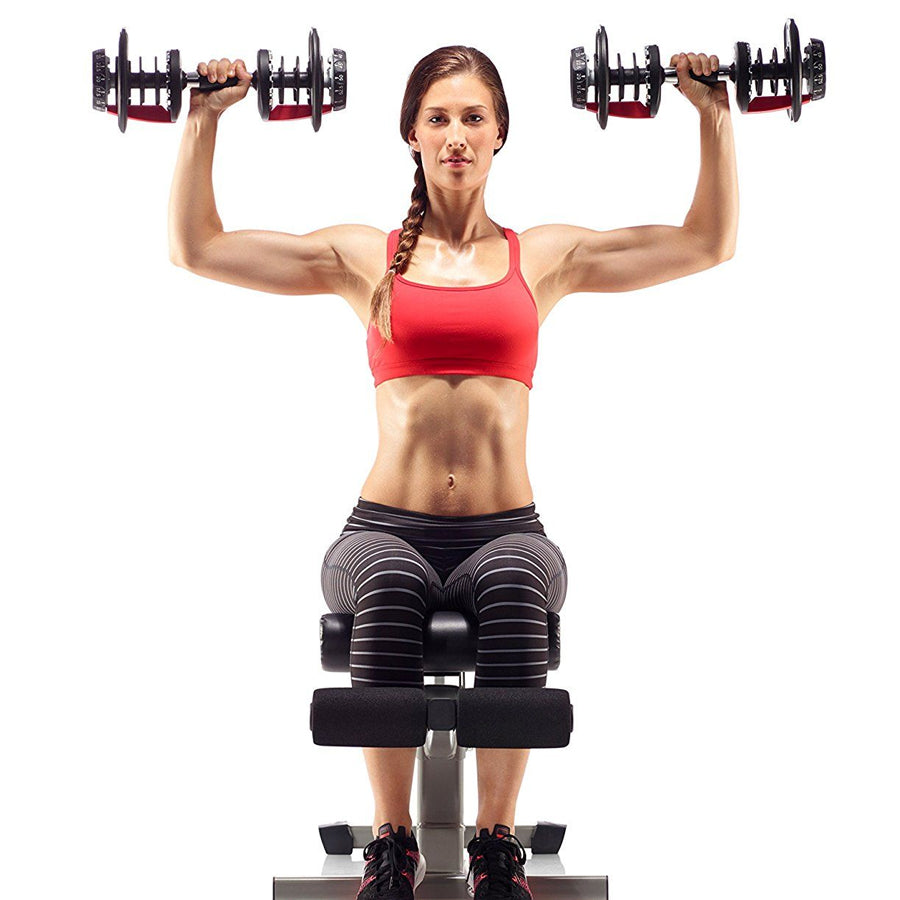Person lifting adjustable dumbbells